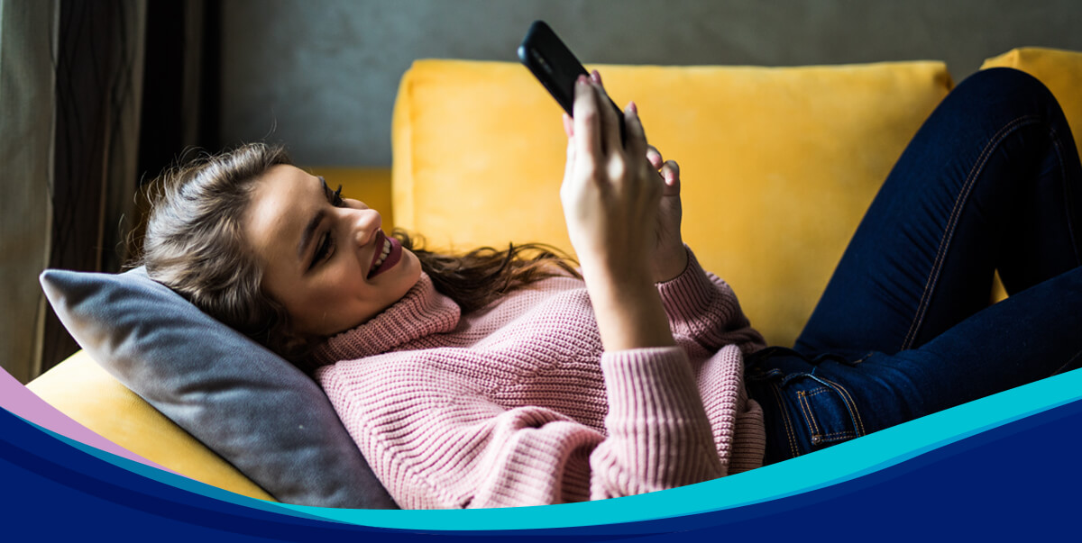 Woman on a sofa with a mobile phone